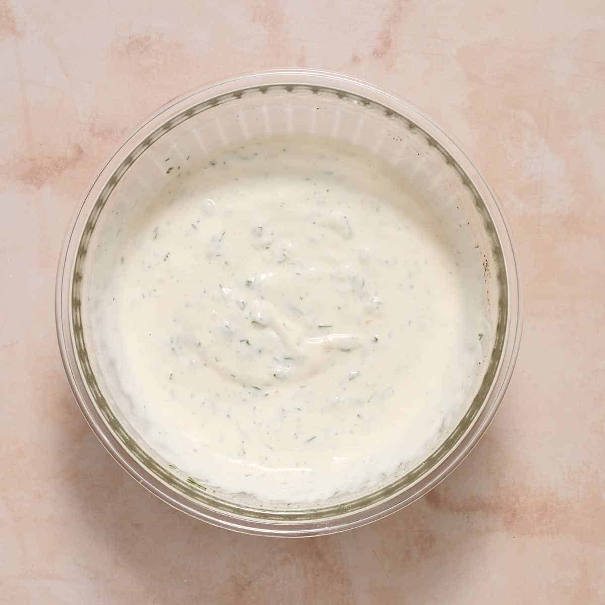 Ranch dressing mixed together in a glass bowl.