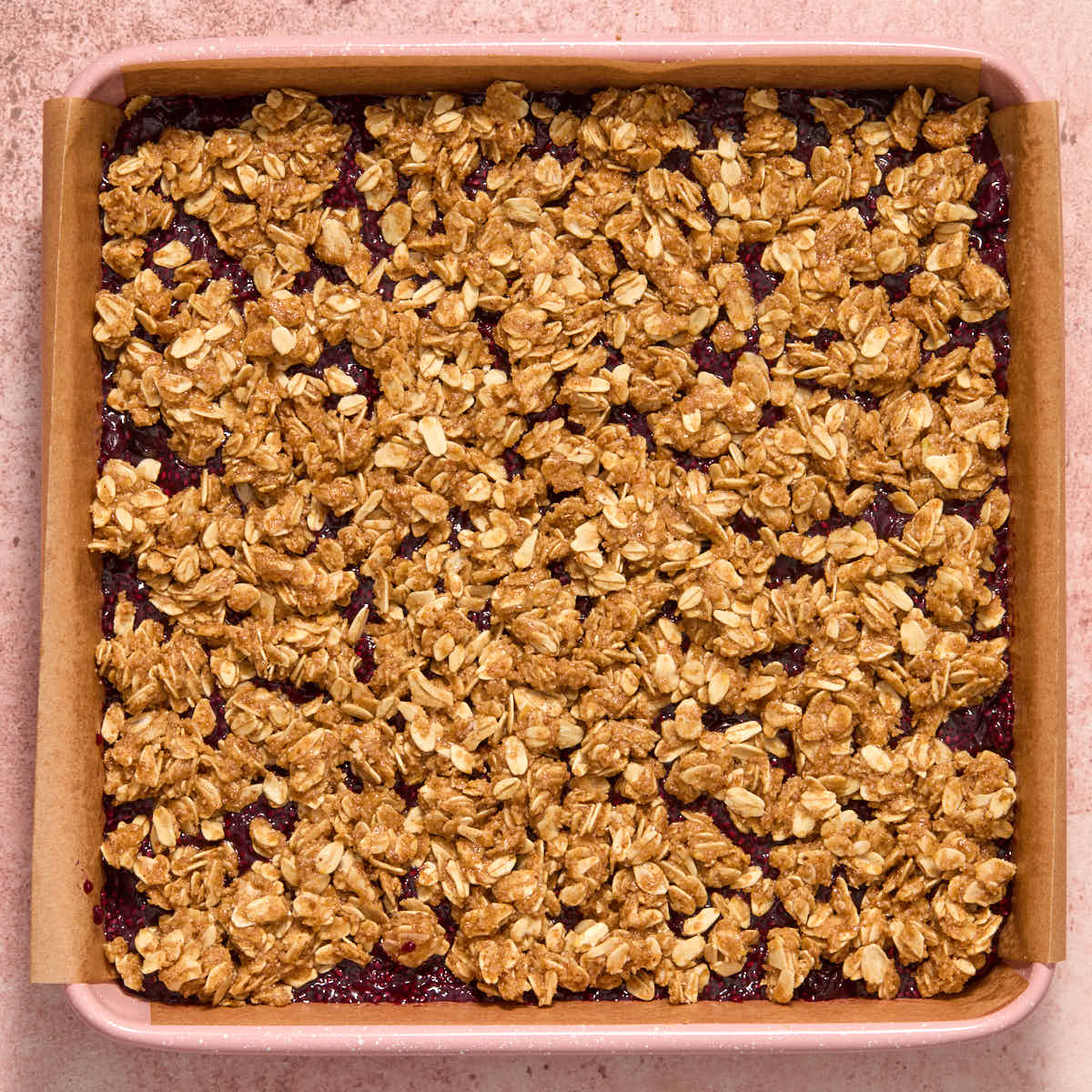 Remaining oat mixture scattered over top of the jam layer.