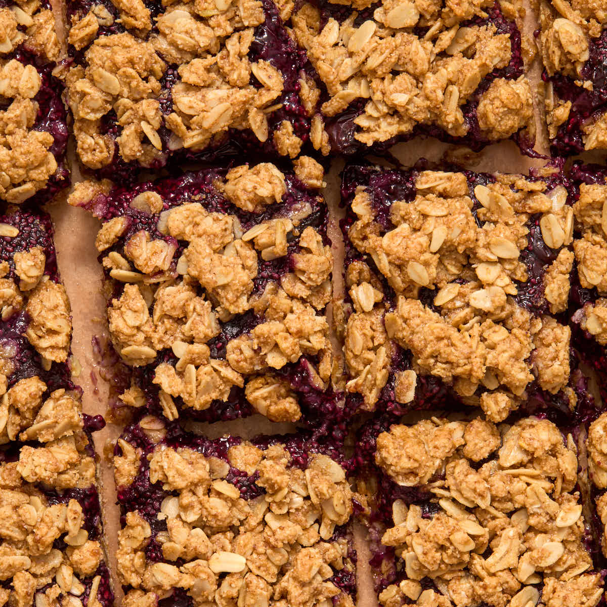 Blueberry bars cut into squares and arranged close together.