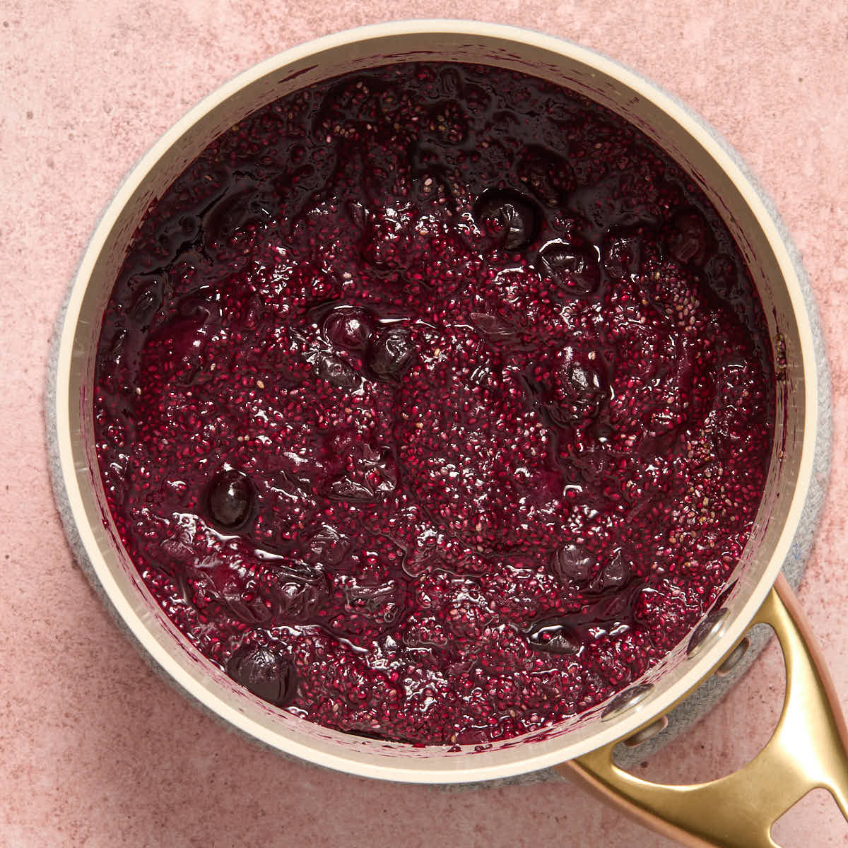 Thickened blueberry chia jam in a small sauce pan.