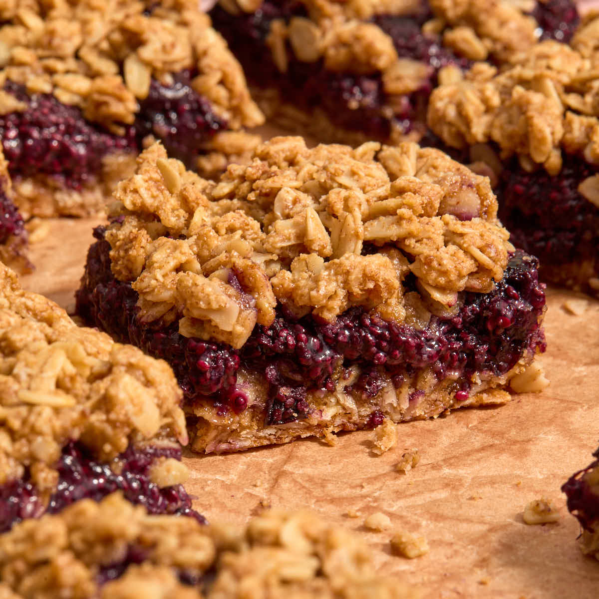 Blueberry breakfast bars on brown parchment paper.