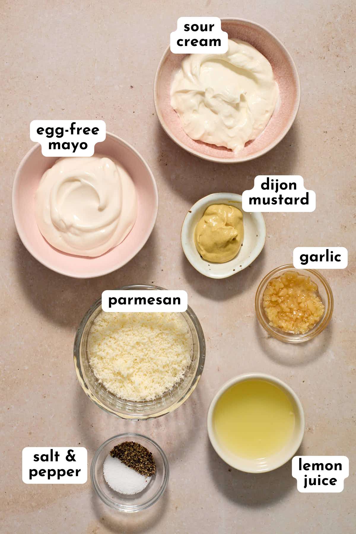 Ingredients to make egg-free caesar dressing arranged individually and labeled.