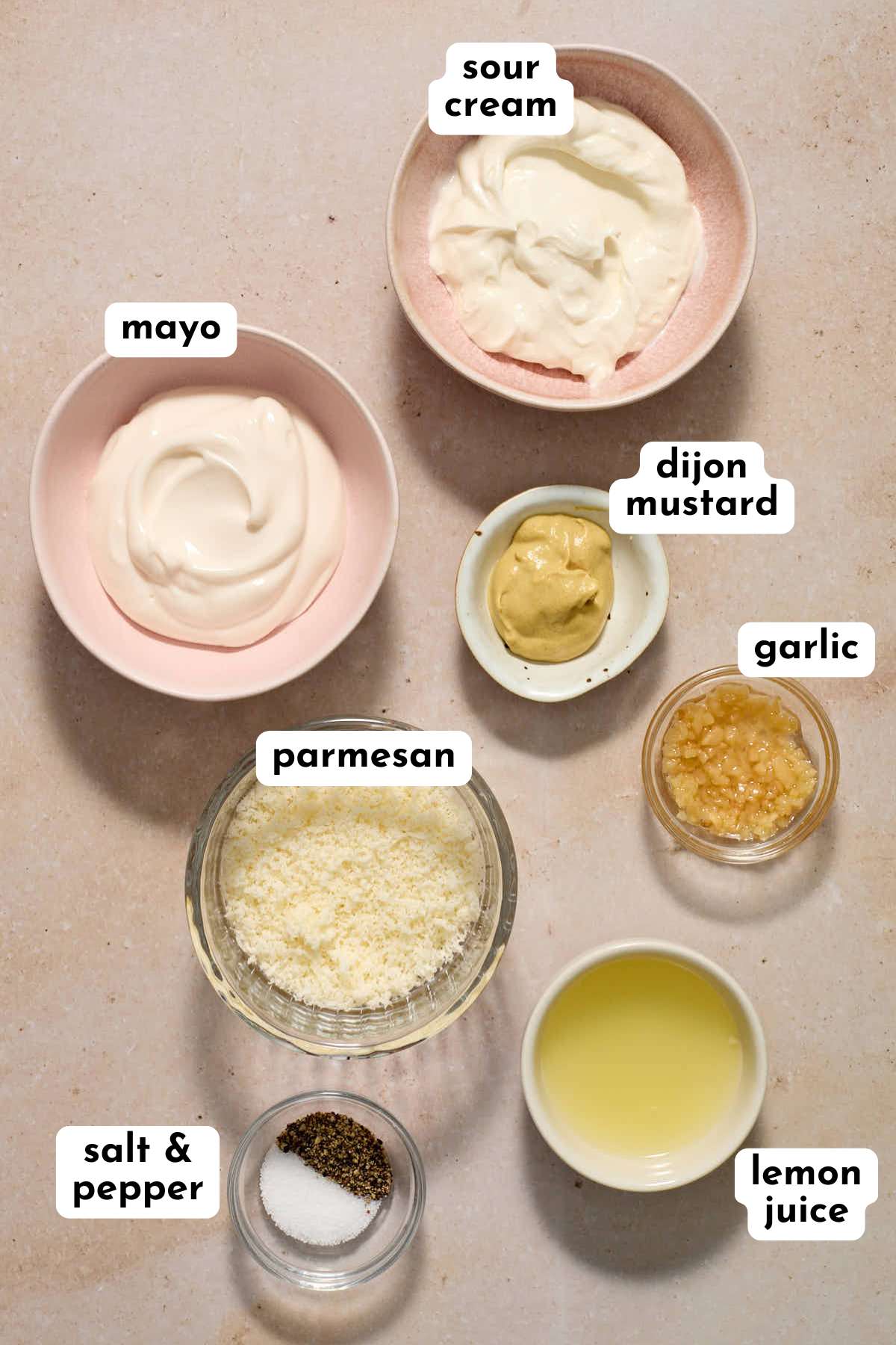 Ingredients to make egg-free caesar dressing arranged individually and labeled.