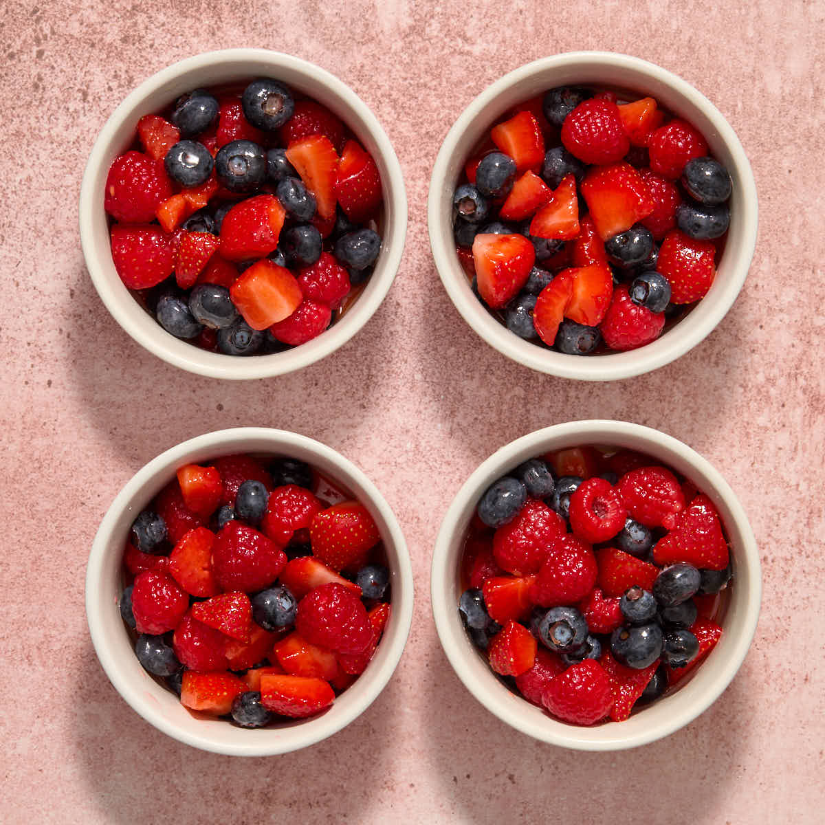 Berry filling divided into 4 white ramekins.