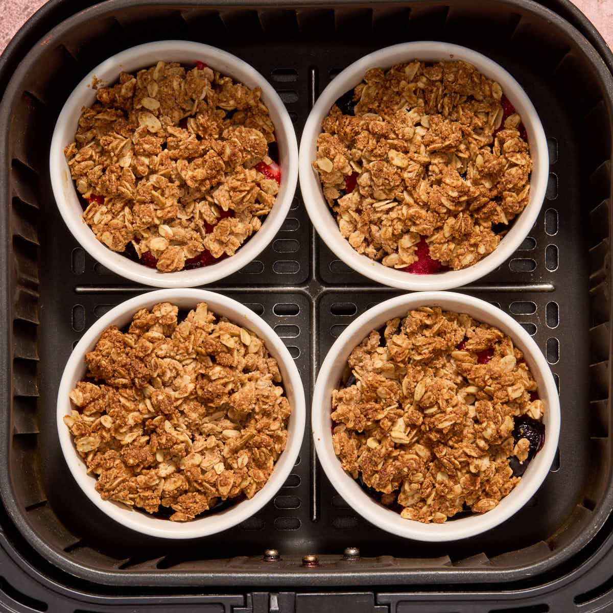 Air fried berry crisps in the air fryer basket.