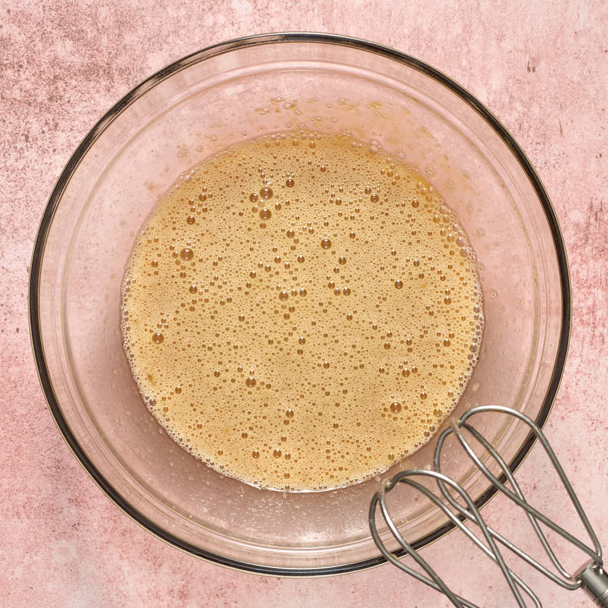 All of the wet ingredients beaten together in a glass bowl.