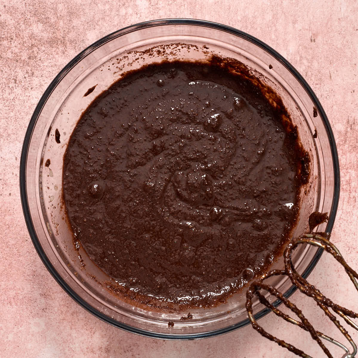 Chocolate cupcake batter in a large glass bowl.