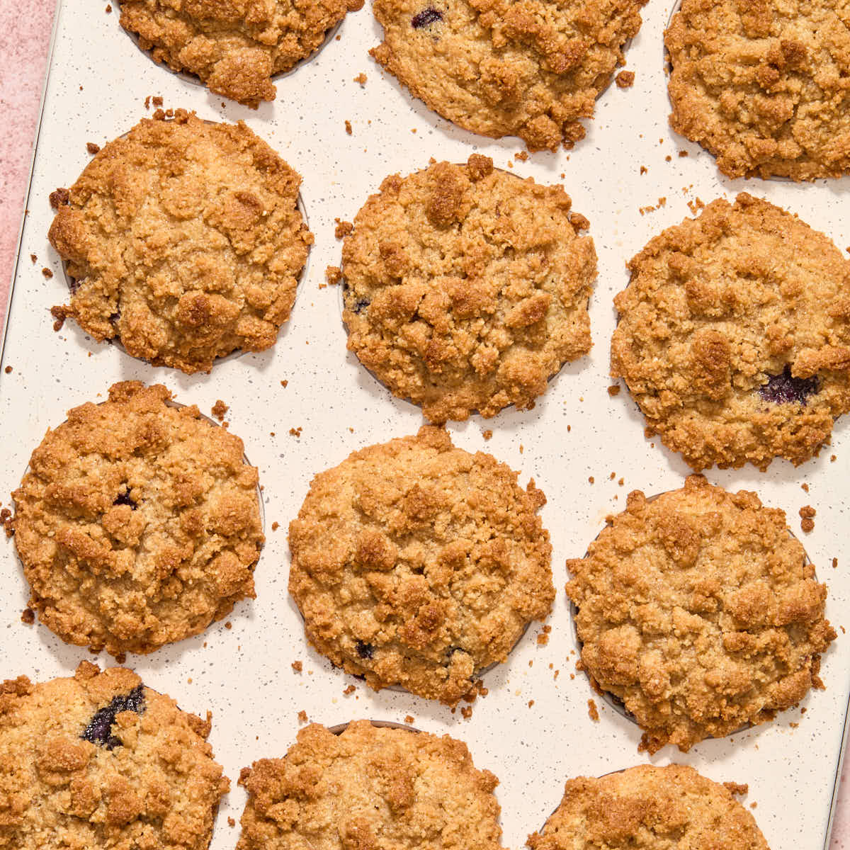 Baked blueberry muffins in a muffin pan.