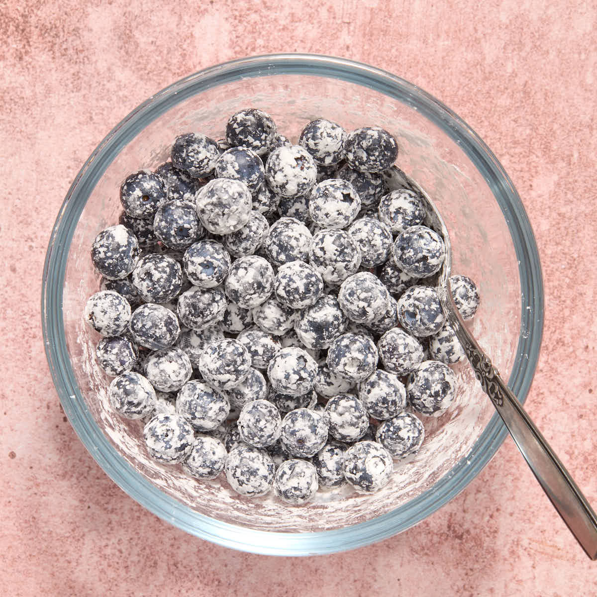 Blueberries tossed with cornstarch in a small glass bowl.