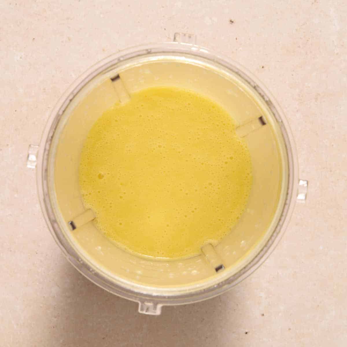 Dressing ingredients blended to a smooth consistency in blender cup.