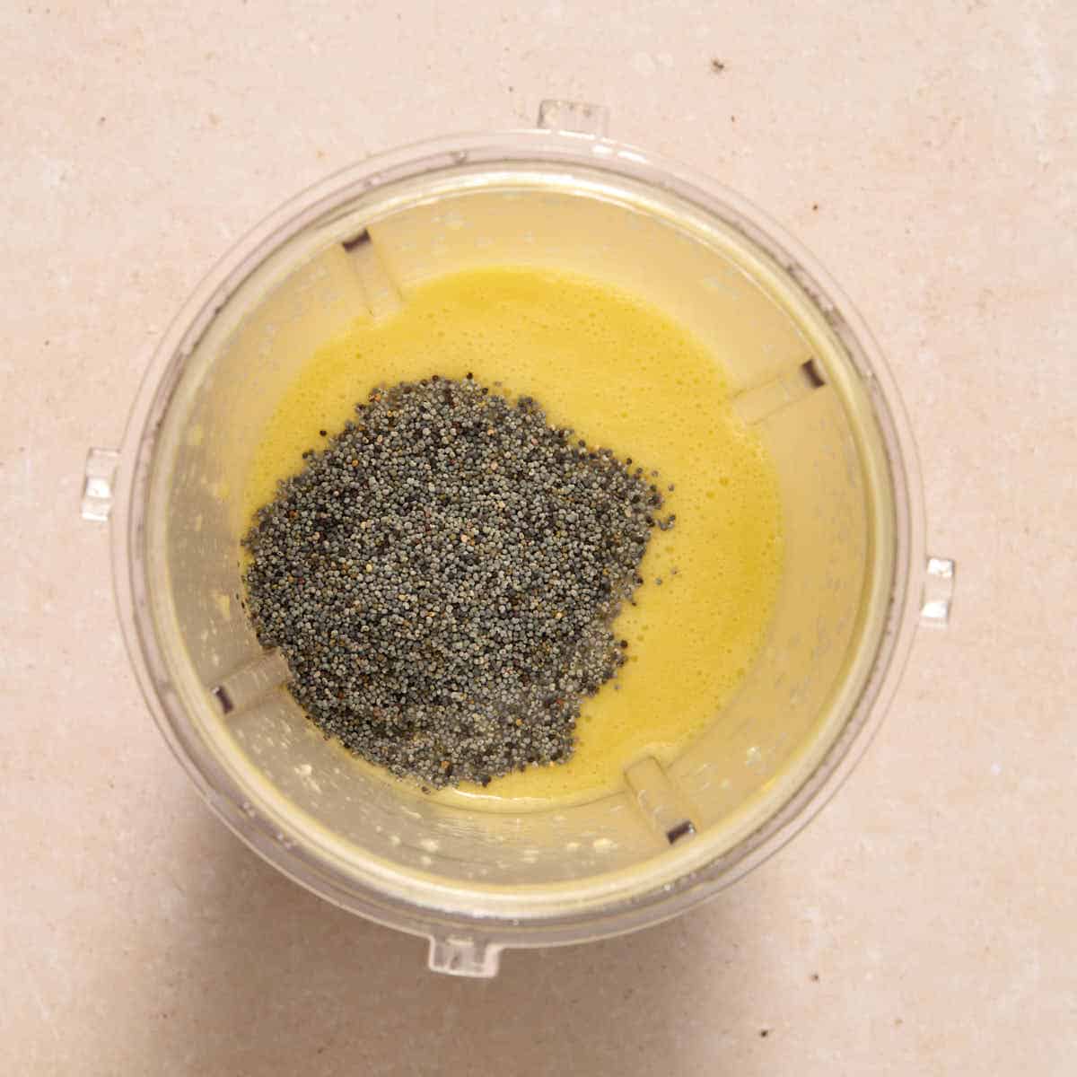 Poppy seeds added to the blender cup.