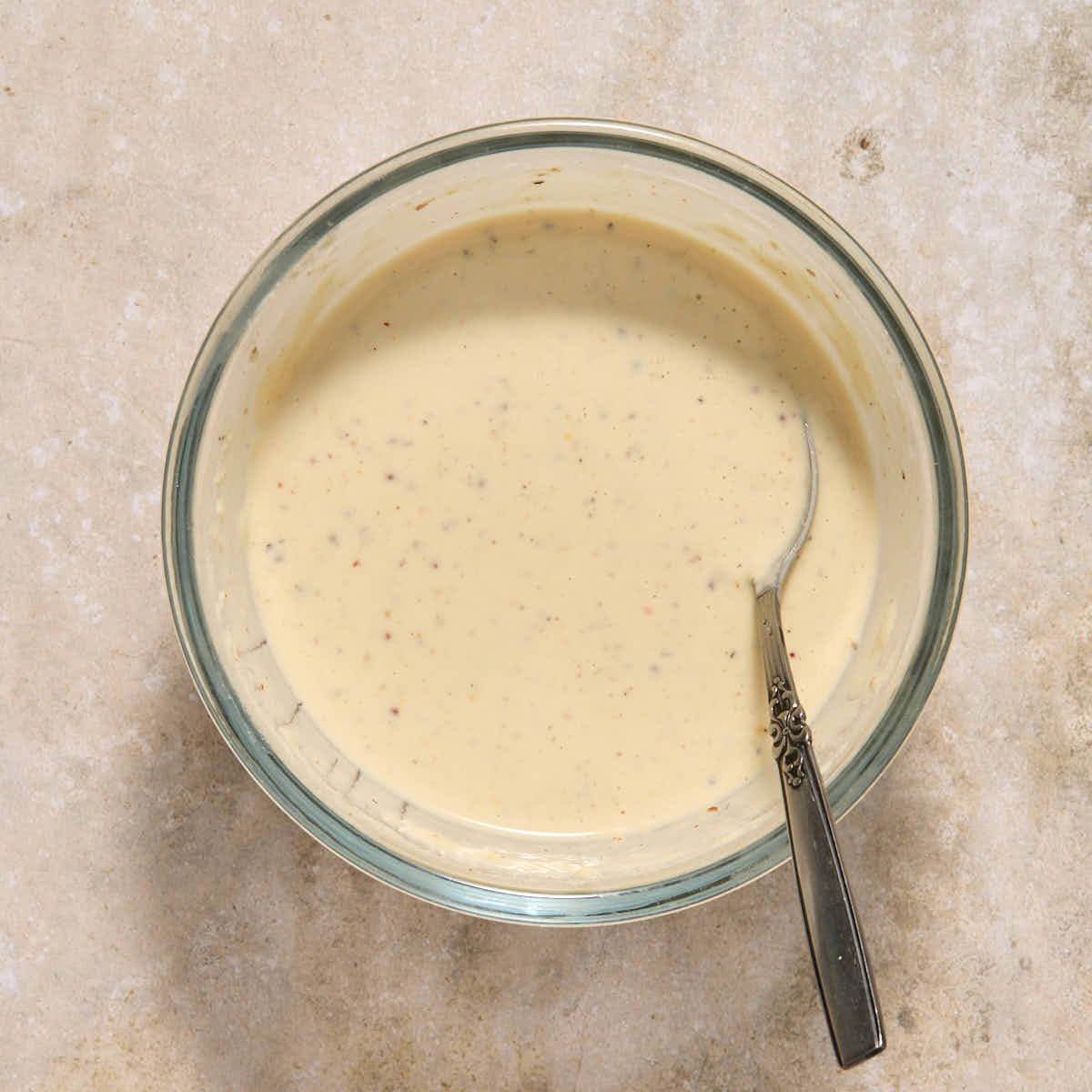 Water mixed into the dressing to thin it out.