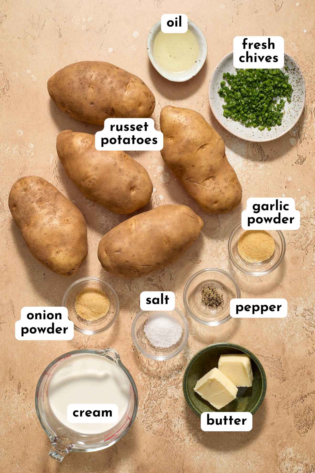 Ingredients to make air fryer mashed potatoes arranged individually and labeled.