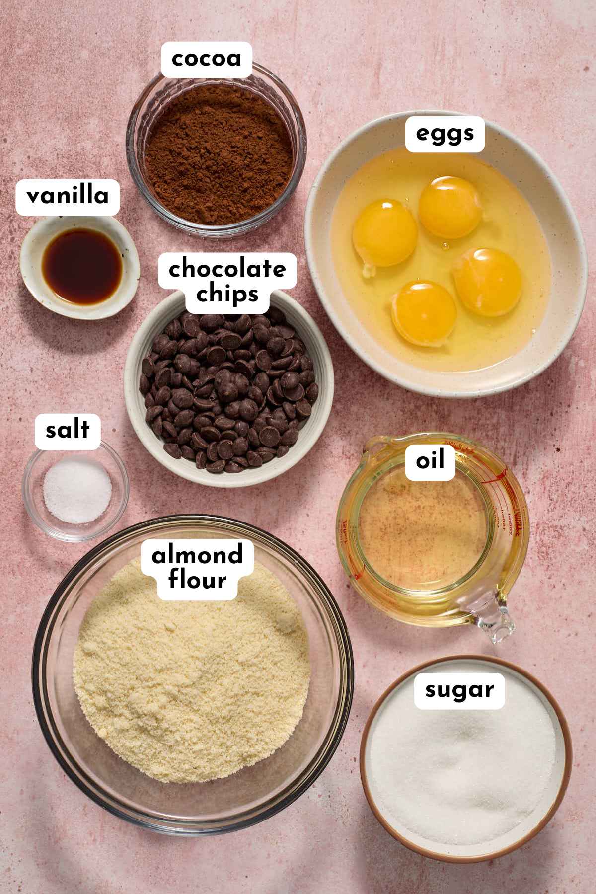 Ingredients to make almond flour brownies arranged in separate bowls and labeled.