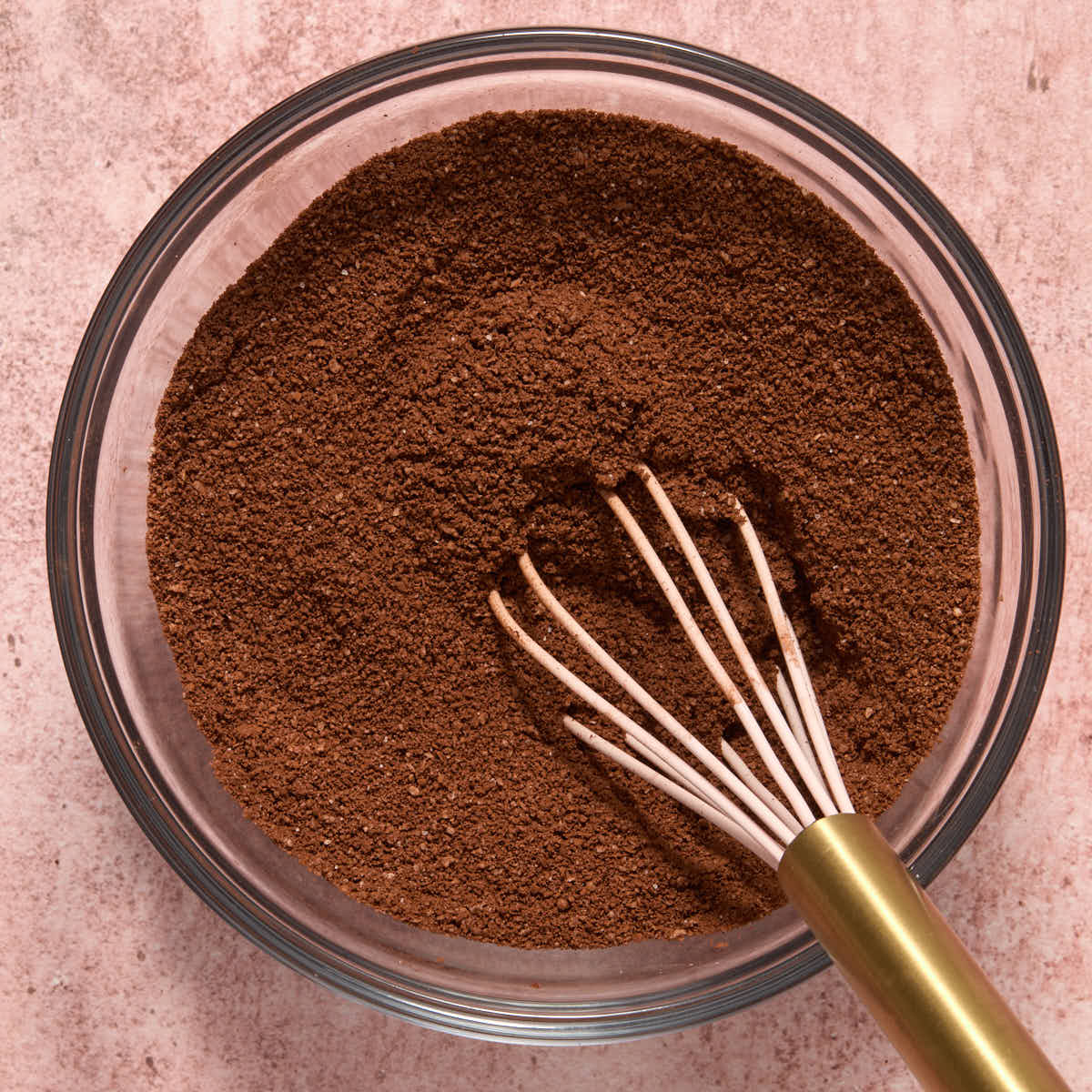 Almond flour, cocoa and salt sifted together in a glass bowl.