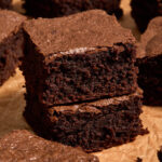Two almond flour brownies stacked together.