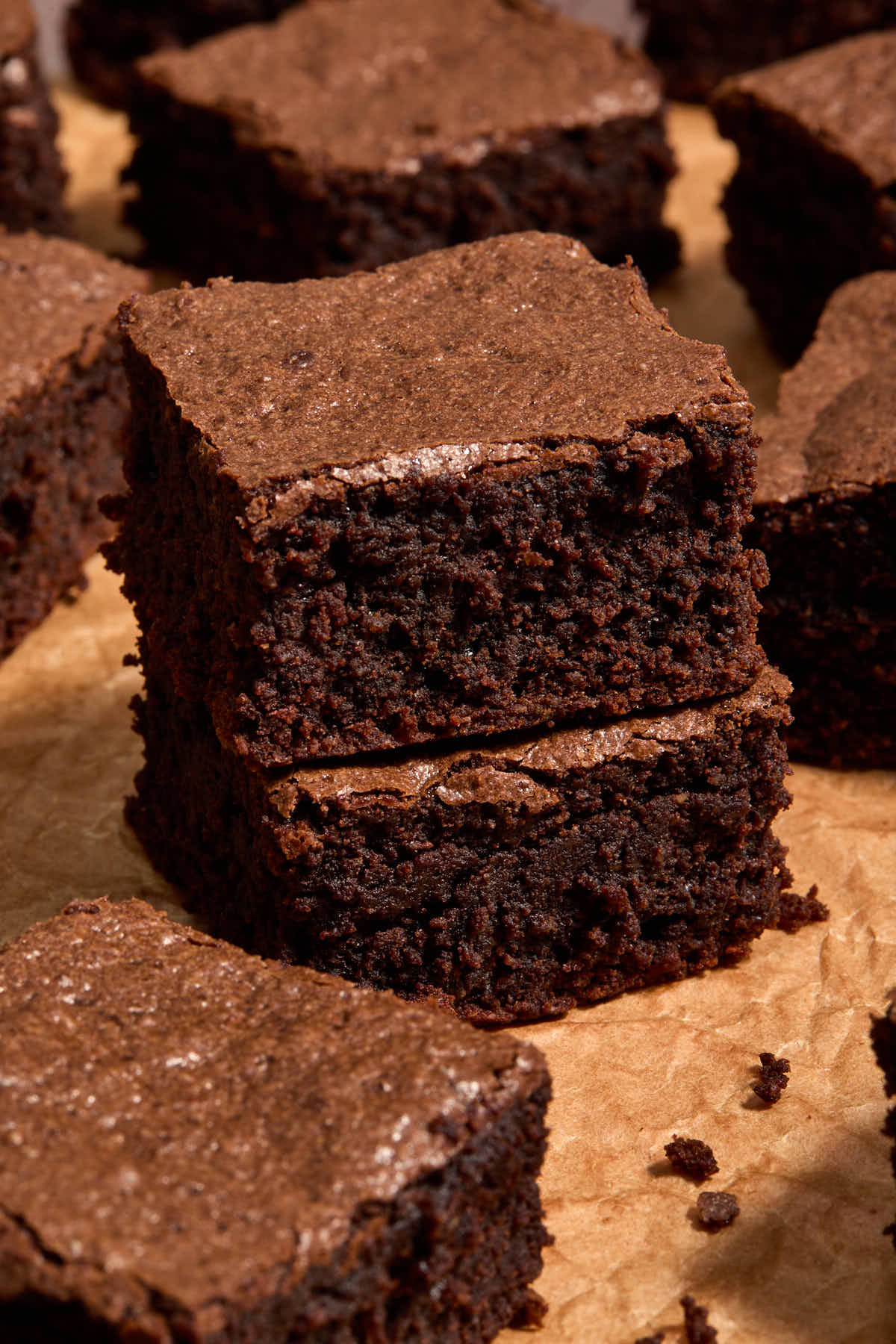 One brownie stacked on another with other brownies around.