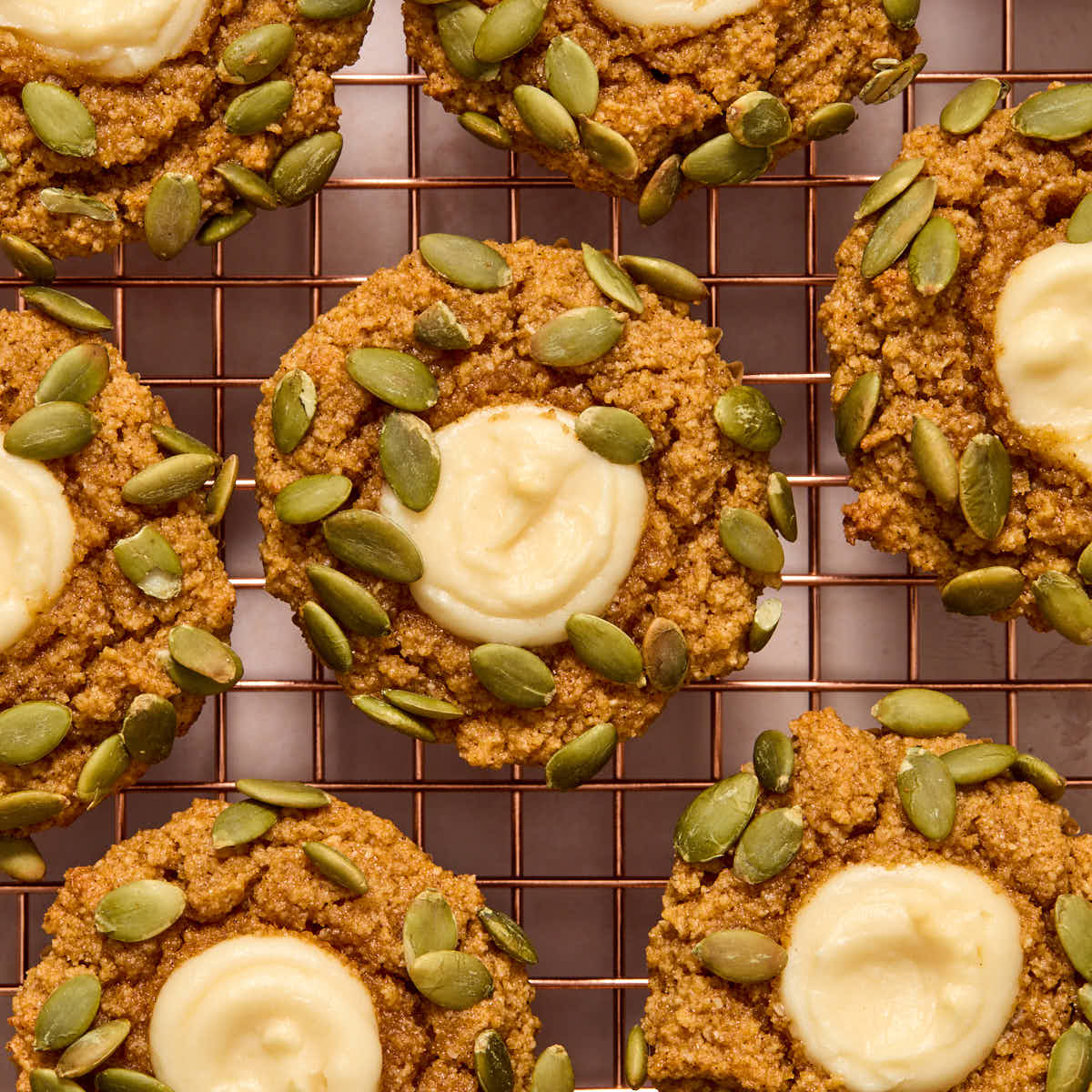 Pumpkin muffins cooling on a wire rack.