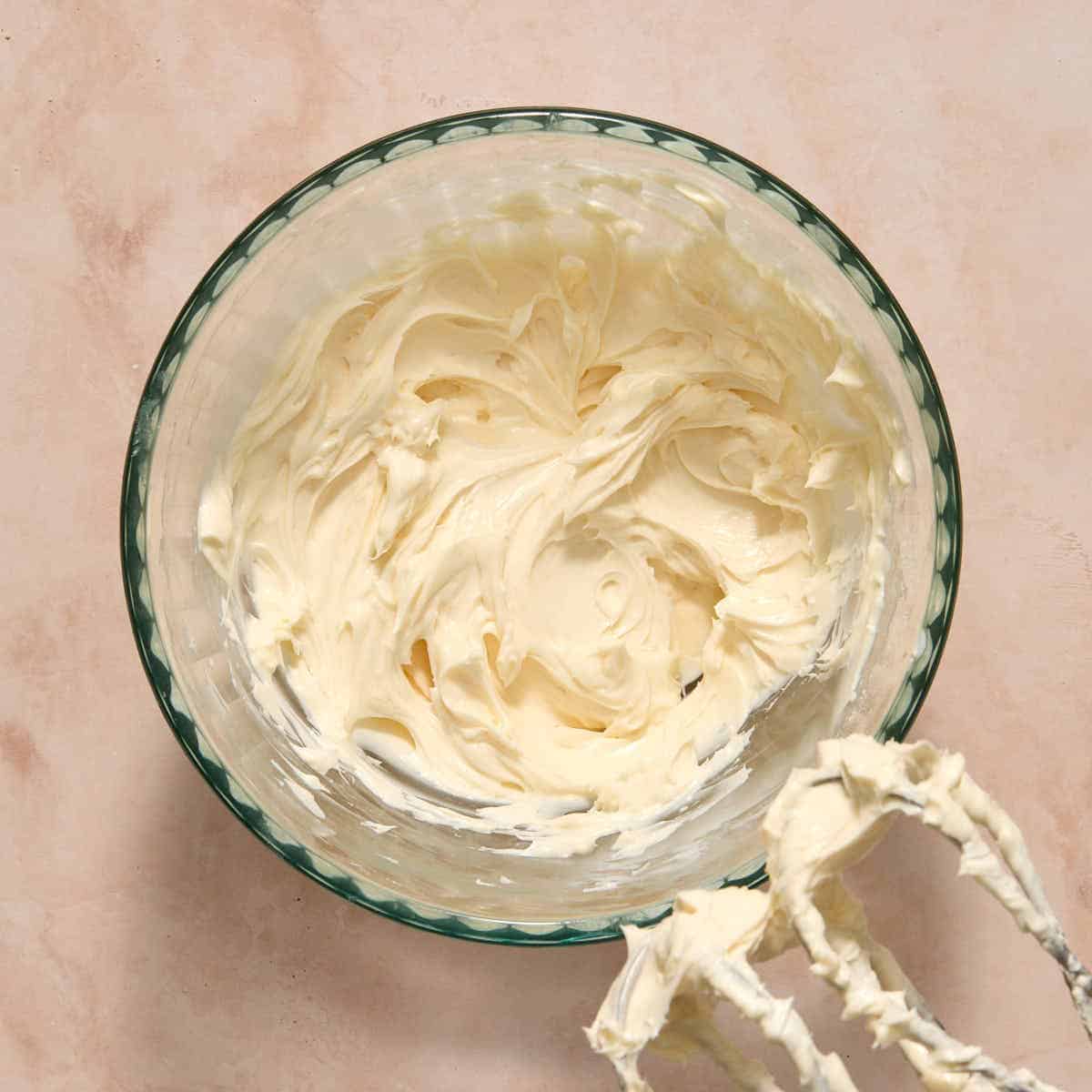 Cream cheese filling whipped together in a glass bowl.