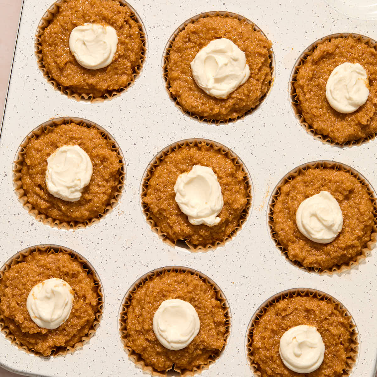 Cream cheese filling piped into the center of each muffin.