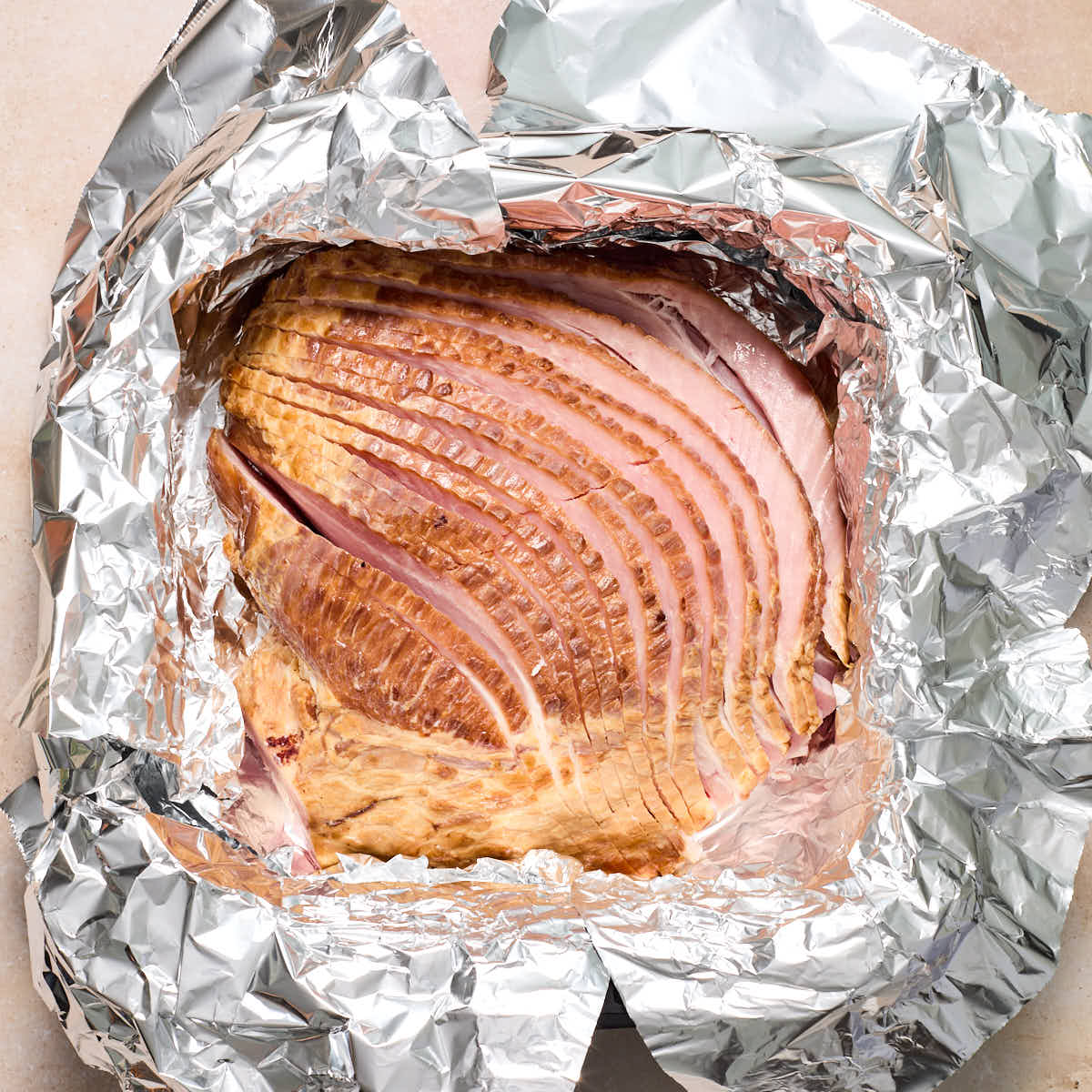 Spiral ham placed in a foil lined air fryer basket.