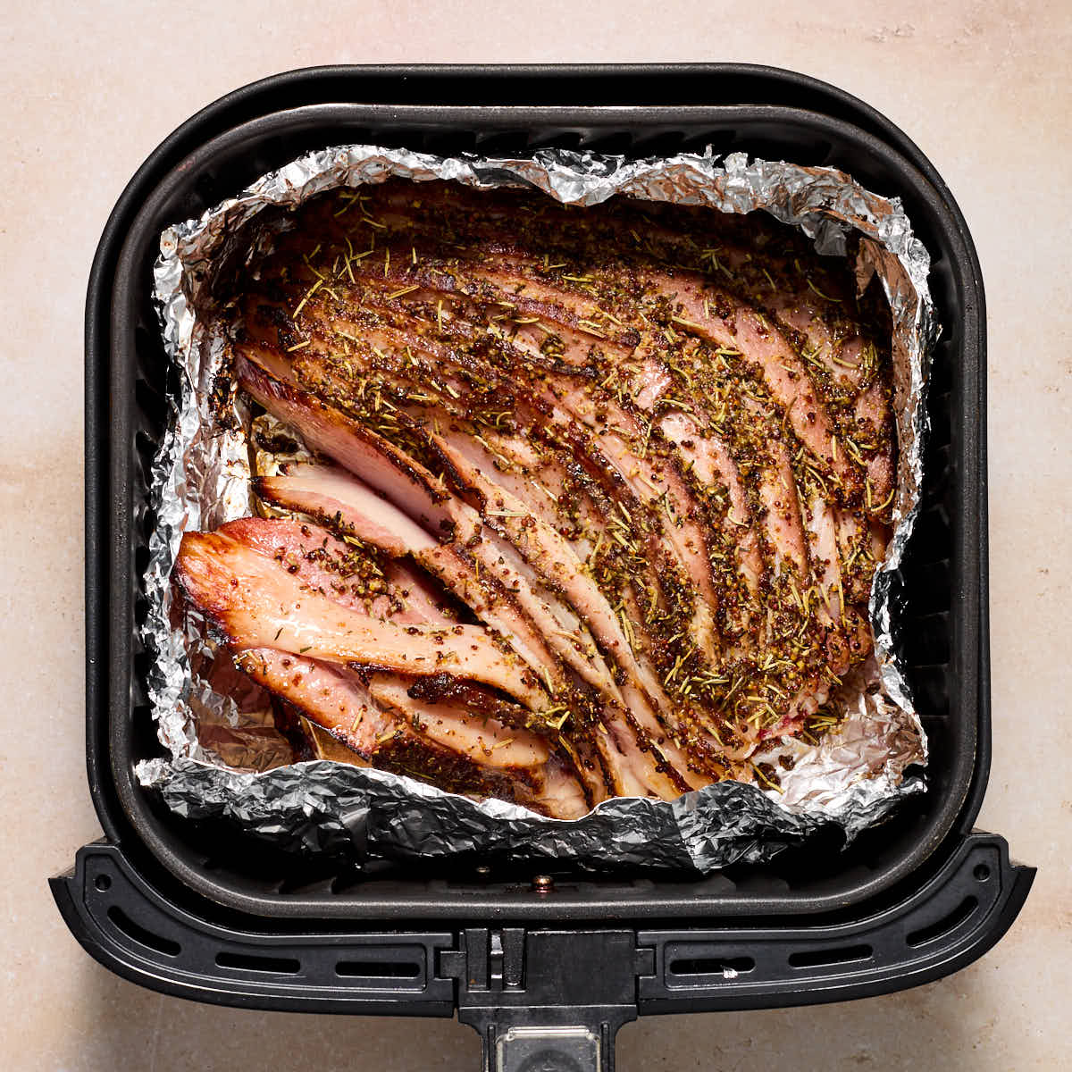 Ham browned and crisped up in air fryer basket.