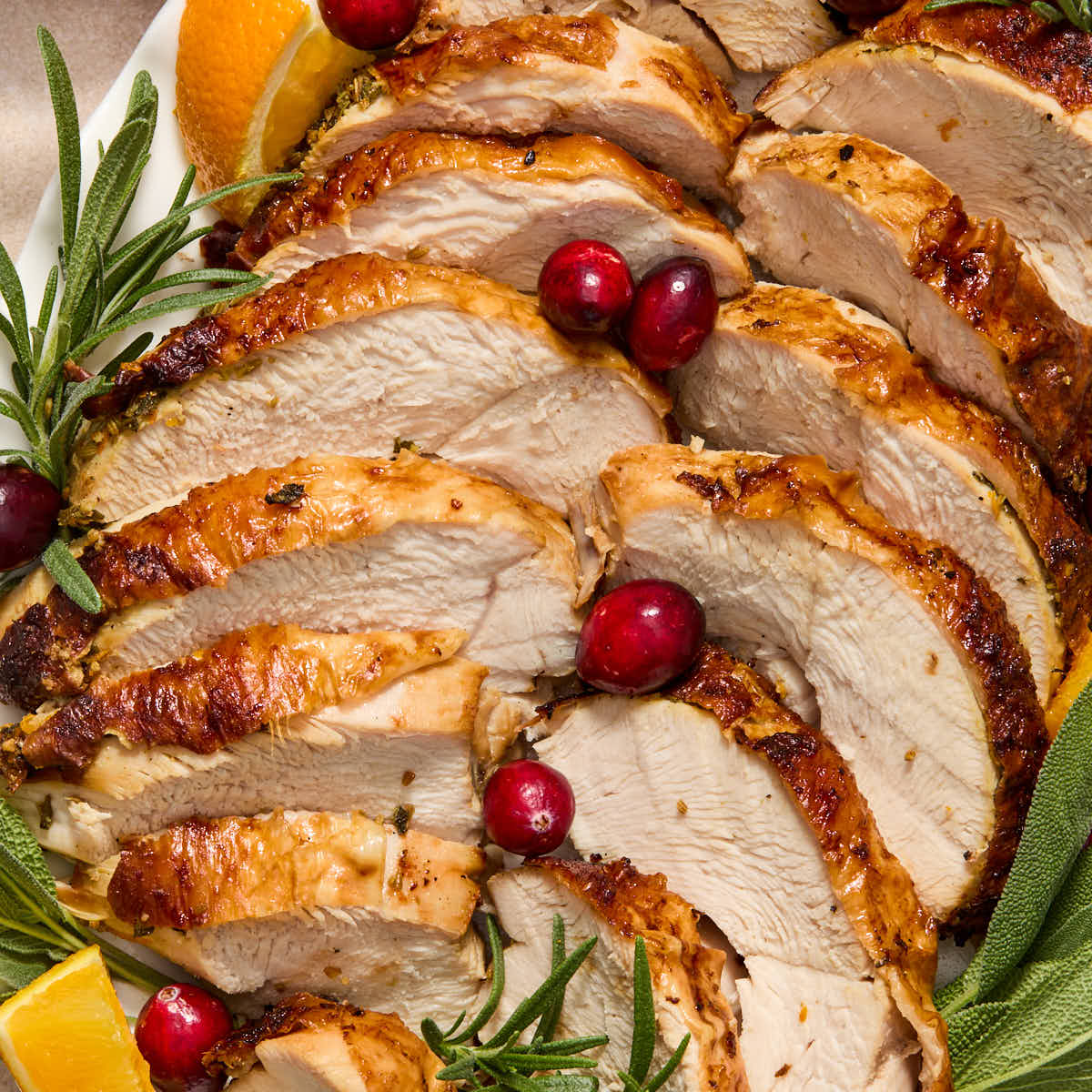 Turkey breast cut into slices and arranged on a platter.
