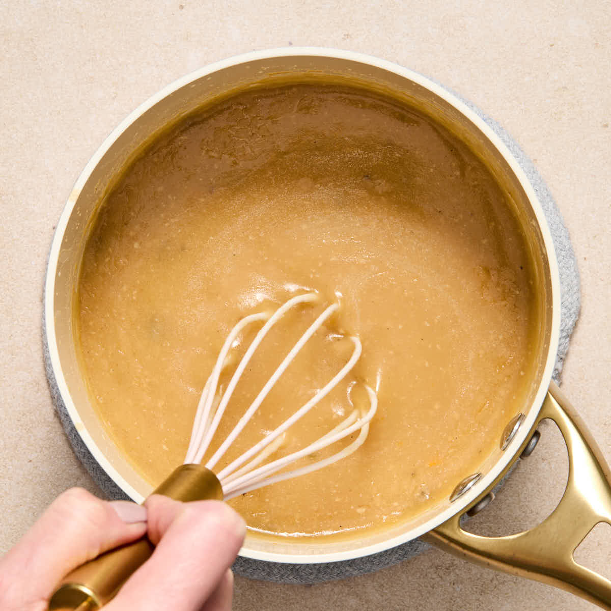 Gravy whisked together in a small saucepan.